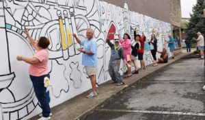 Seniors painting a mural